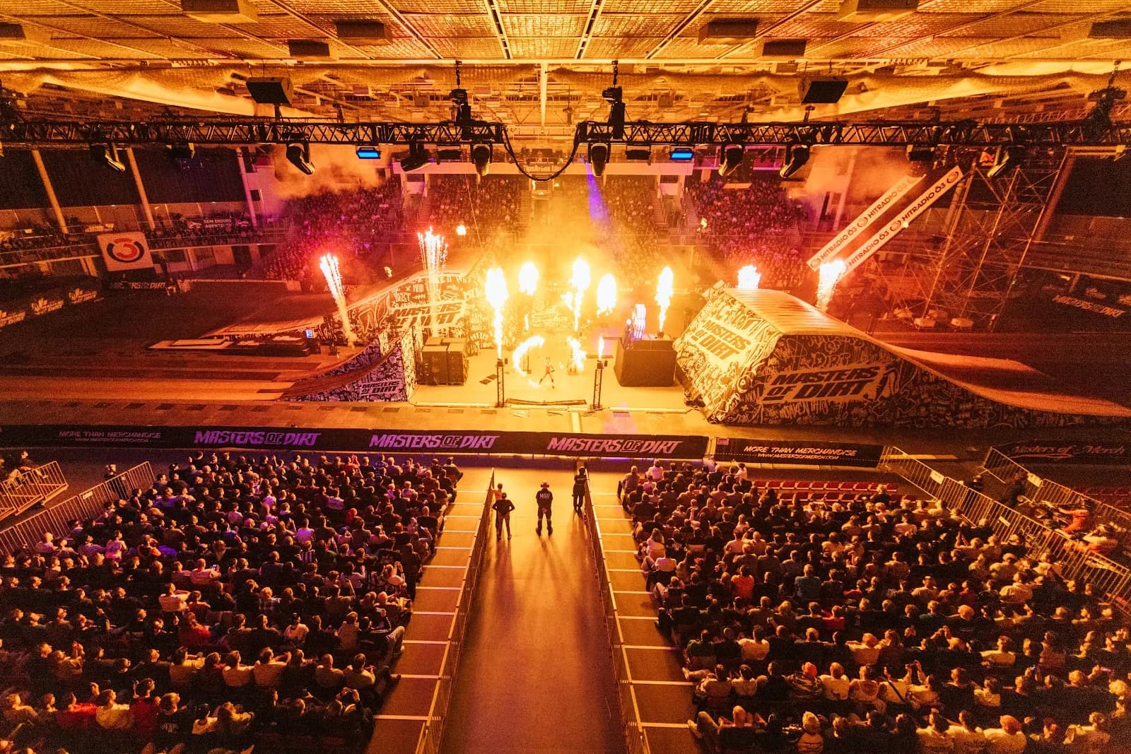 Packed arena in Linz from above, golden pyro fountains over the track