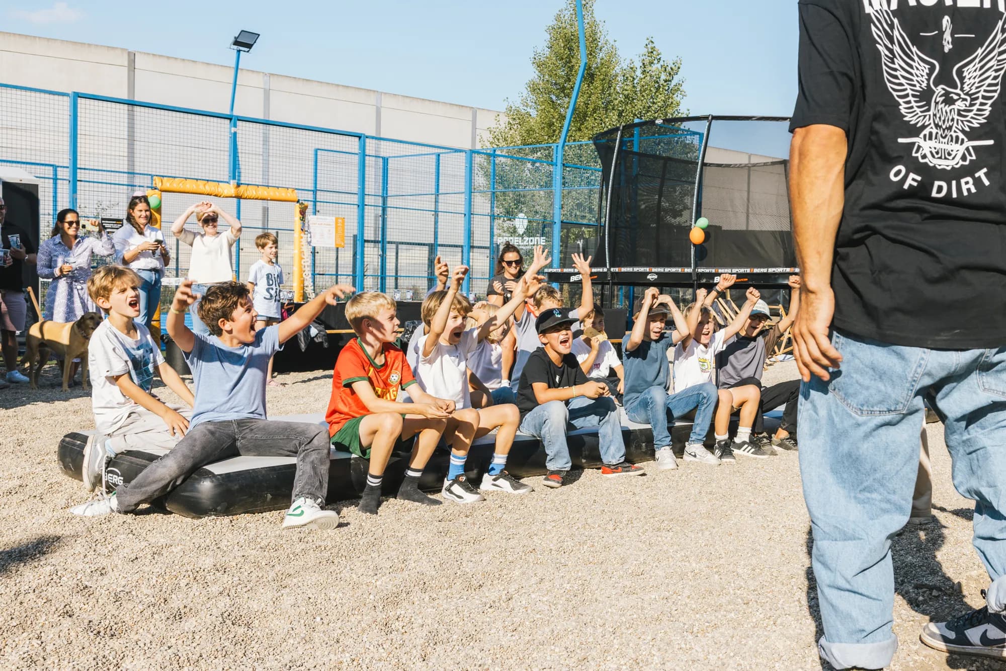 A group of kids cheering at a birthday party at M.O.D World