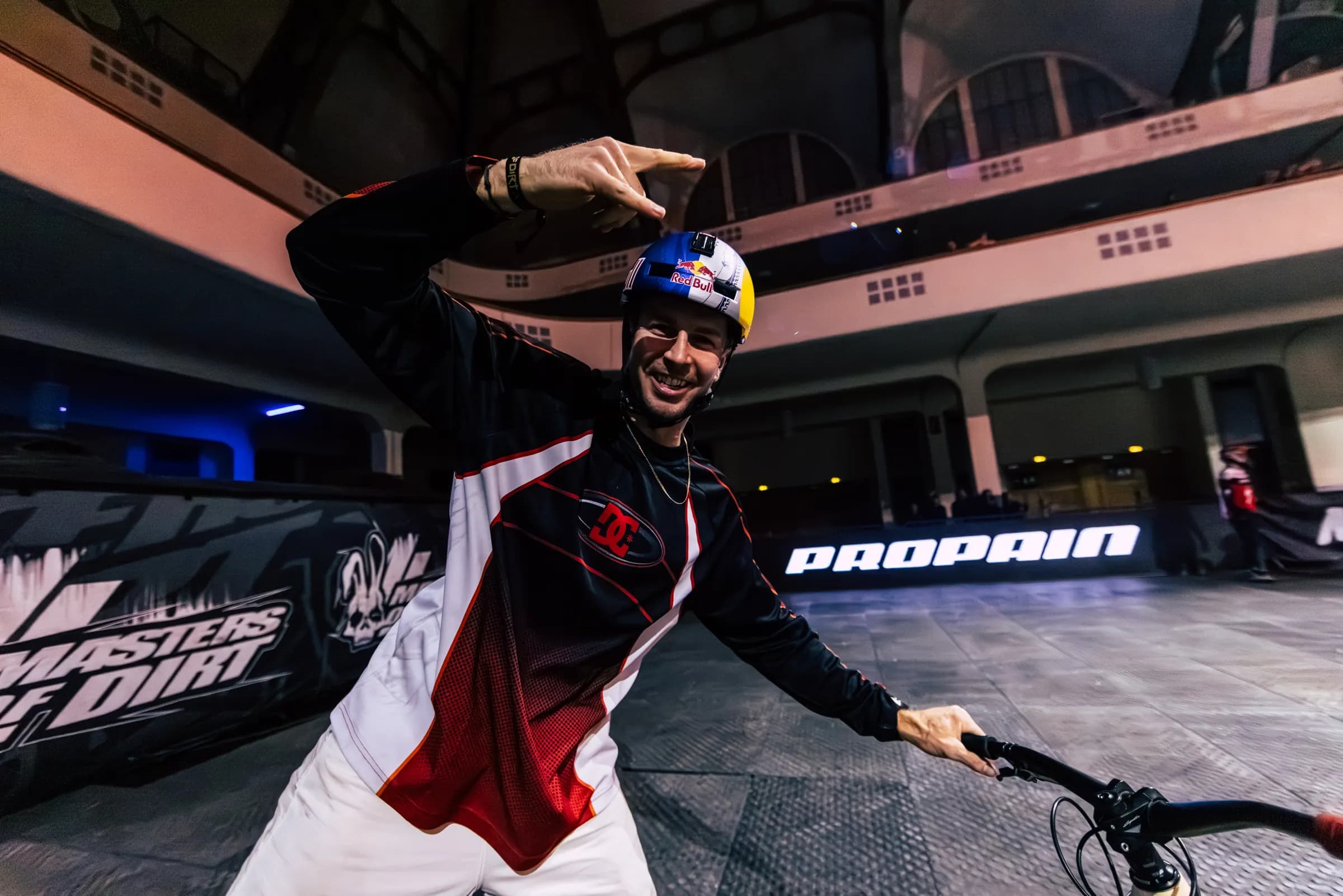 Dawid Godziek celebrating with his MTB in the arena